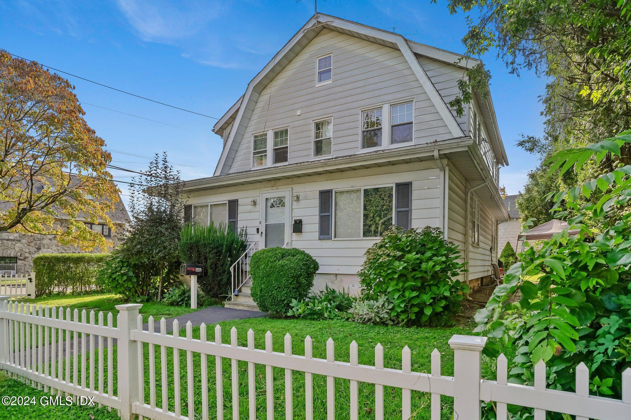 8 Sheep Hill Road, Unit TOP Riverside, CT 06878 - Photo 1 of 11 a front view of a house with a yard