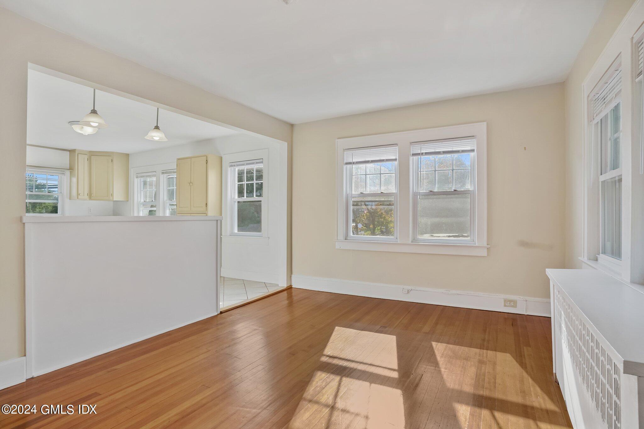 8 Sheep Hill Road, Unit TOP Riverside, CT 06878 - Photo 4 of 11 a view of an empty room with window and wooden floor