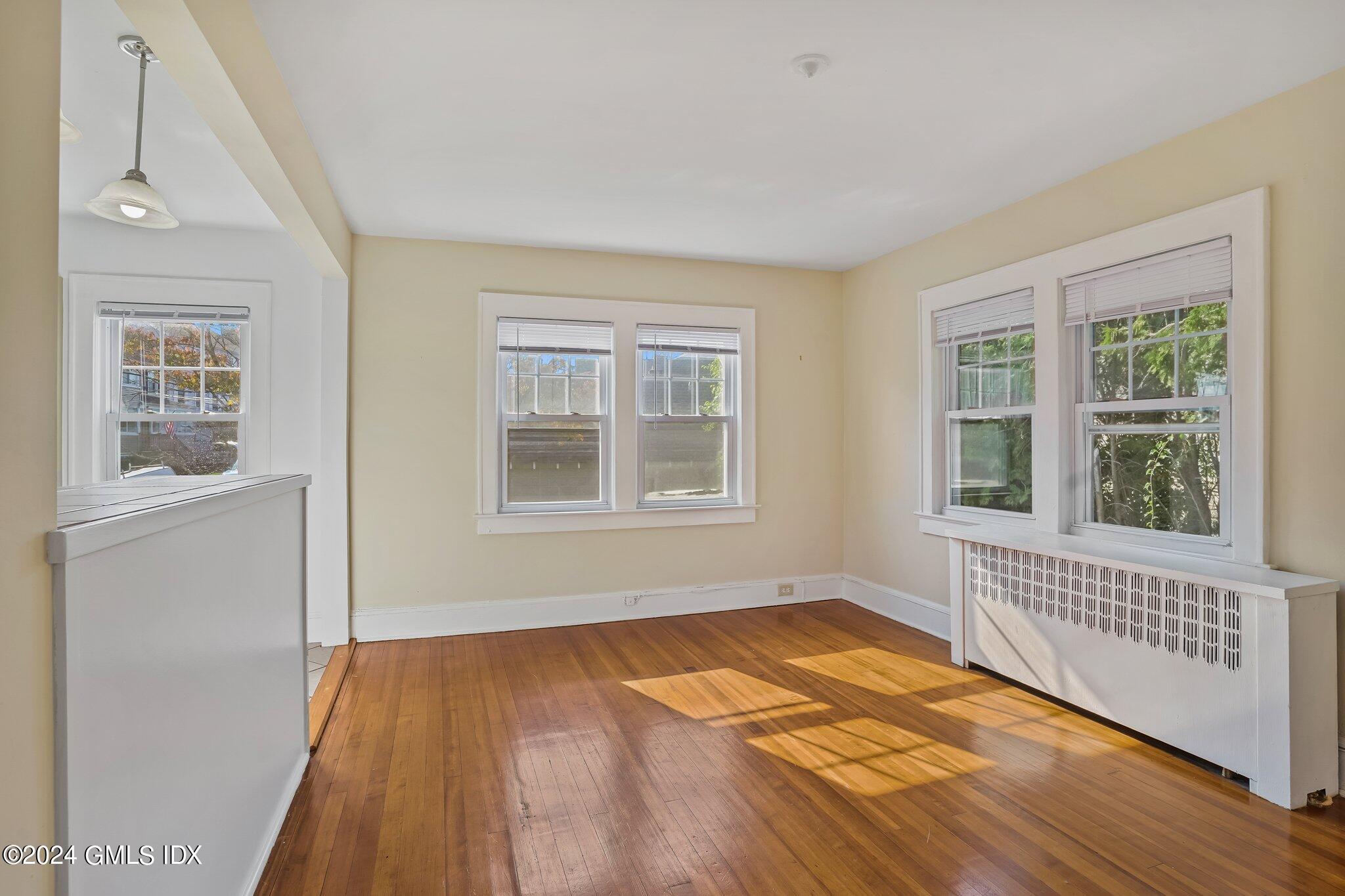 8 Sheep Hill Road, Unit TOP Riverside, CT 06878 - Photo 5 of 11 a view of an empty room with a window and wooden floor