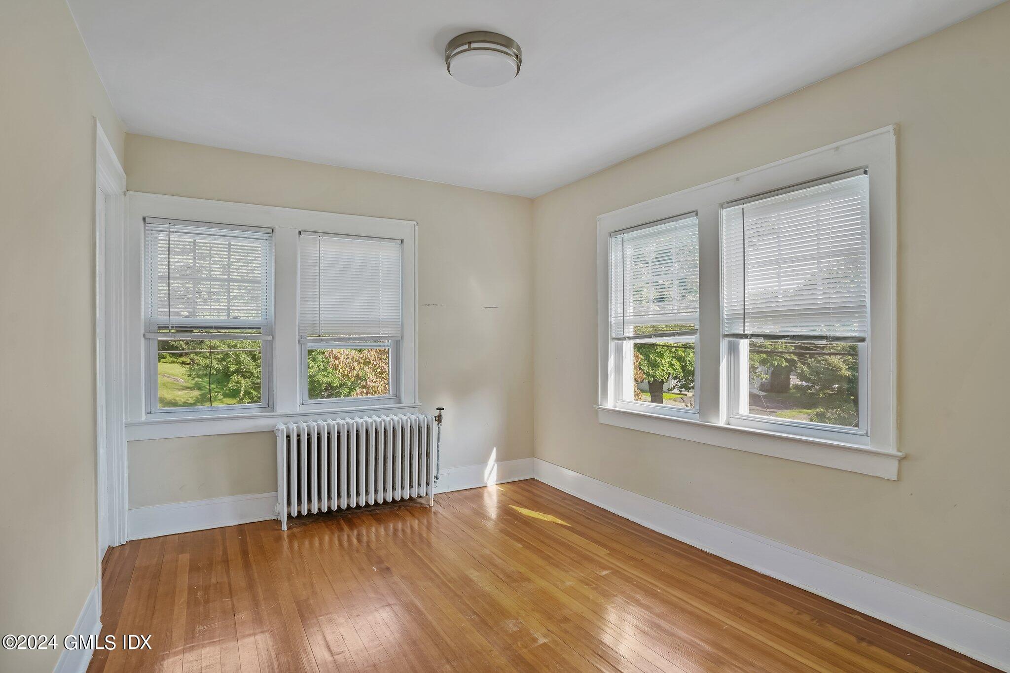8 Sheep Hill Road, Unit TOP Riverside, CT 06878 - Photo 6 of 11 a view of an empty room with wooden floor and a window