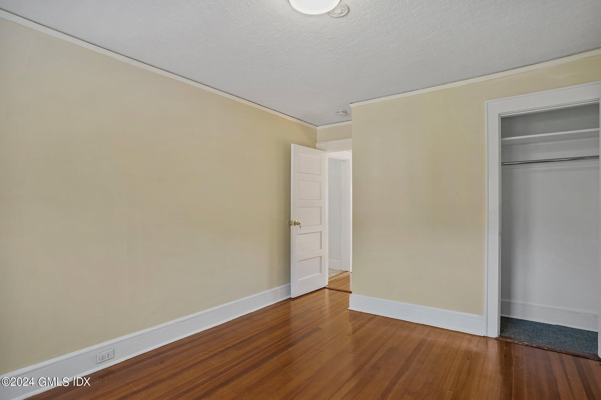 8 Sheep Hill Road, Unit TOP Riverside, CT 06878 - Photo 7 of 11 a view of an empty room with wooden floor