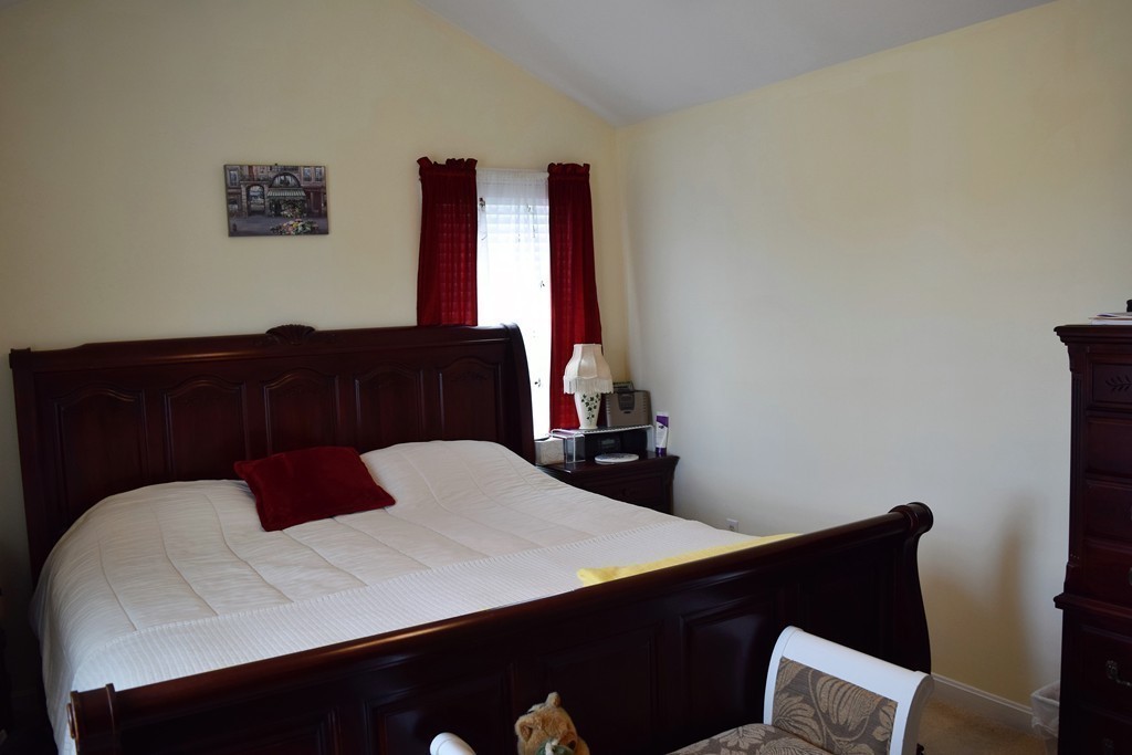 102 Howland Road Freetown, MA 02702 - Photo 13 of 30 a bedroom with a bed and a chair