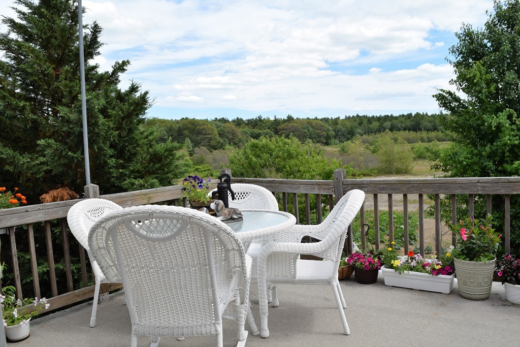 102 Howland Road Freetown, MA 02702 - Photo 8 of 30 a roof deck with table and chairs potted plants with sky view