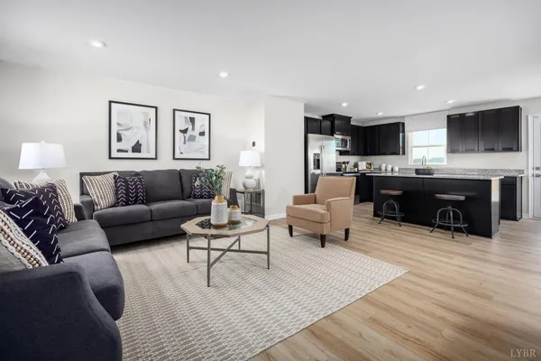 a living room with furniture a rug and a flat screen tv
