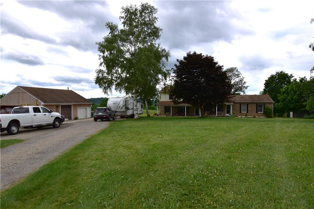 628 Patterson Road Apollo, PA 15613 - Photo 13 of 17 a front view of a house with a garden and trees