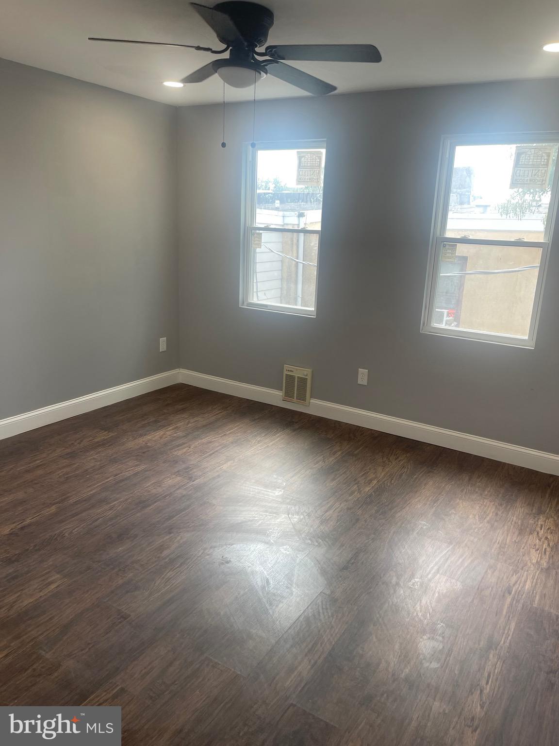 5618 Appletree Street, Unit 2 Philadelphia, PA 19139 - Photo 3 of 11 an empty room with wooden floor and windows