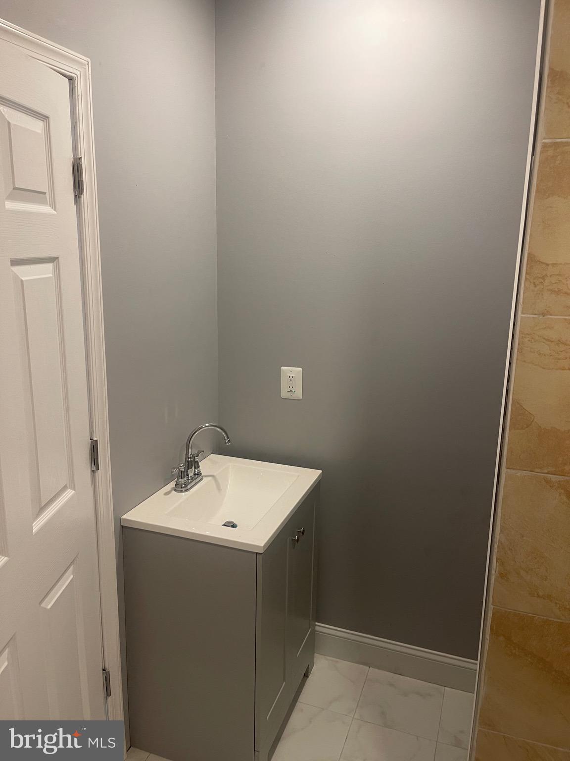 5618 Appletree Street, Unit 2 Philadelphia, PA 19139 - Photo 10 of 11 a bathroom with a sink and mirror