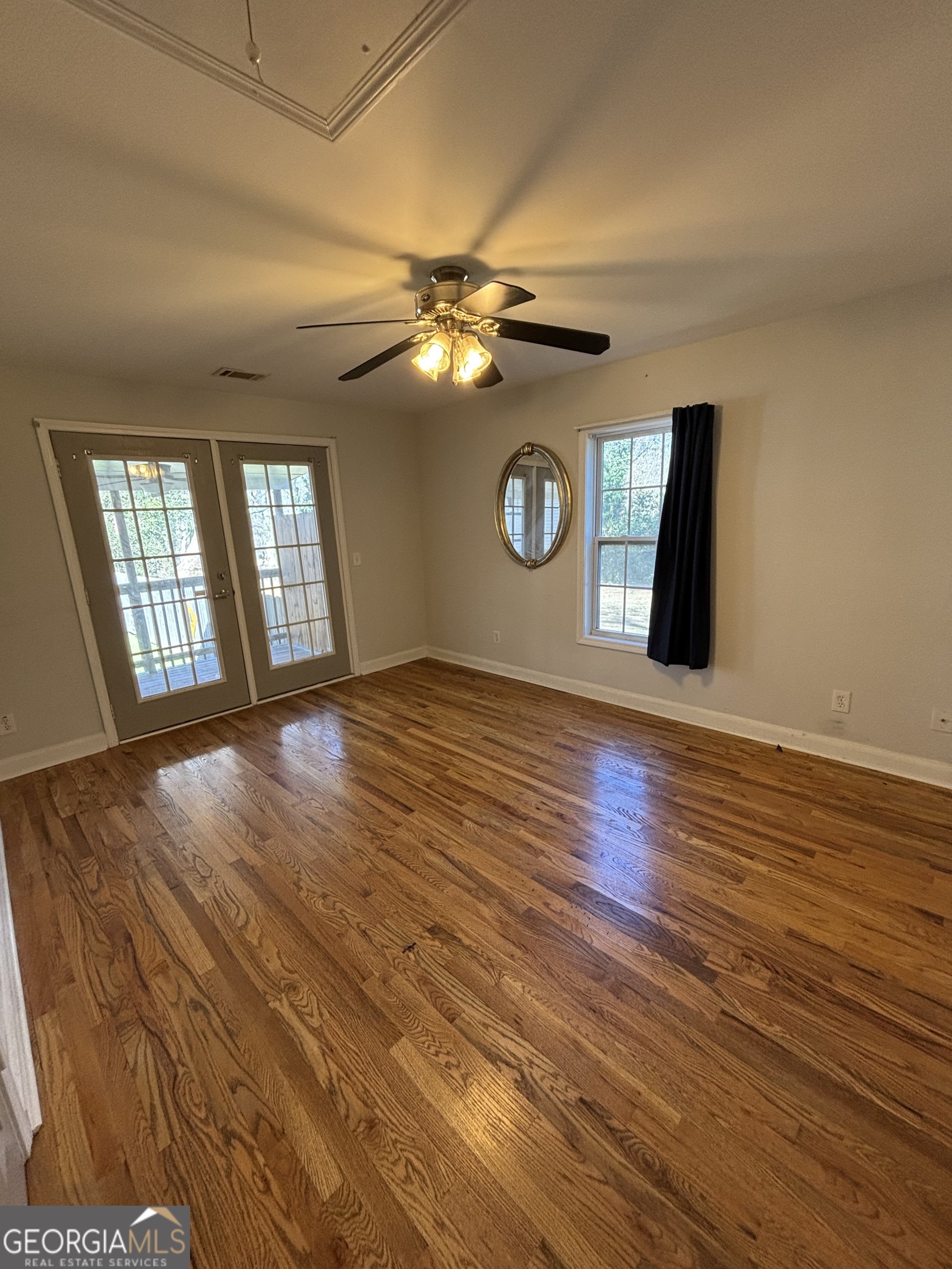 88 East Washington Street Newnan, GA 30263 - Photo 9 of 9 a view of an empty room with a window and wooden floor