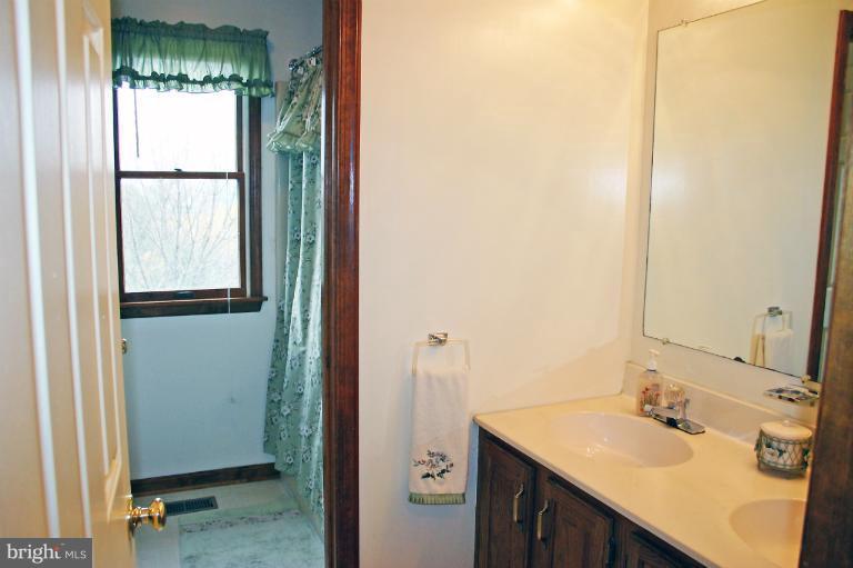 728 Ridge Road Finksburg, MD 21048 - Photo 1 of 25 a bathroom with a sink and a mirror