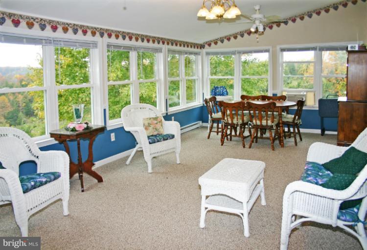 728 Ridge Road Finksburg, MD 21048 - Photo 5 of 25 a view of a dining room with furniture a chandelier and large windows