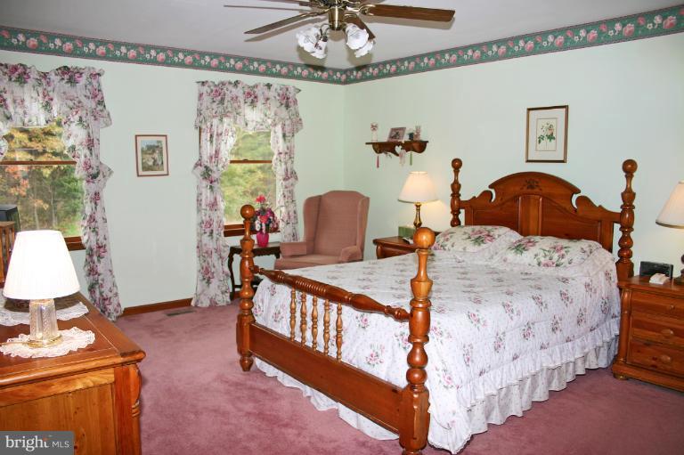 728 Ridge Road Finksburg, MD 21048 - Photo 8 of 25 a bedroom with bed and a table lamp