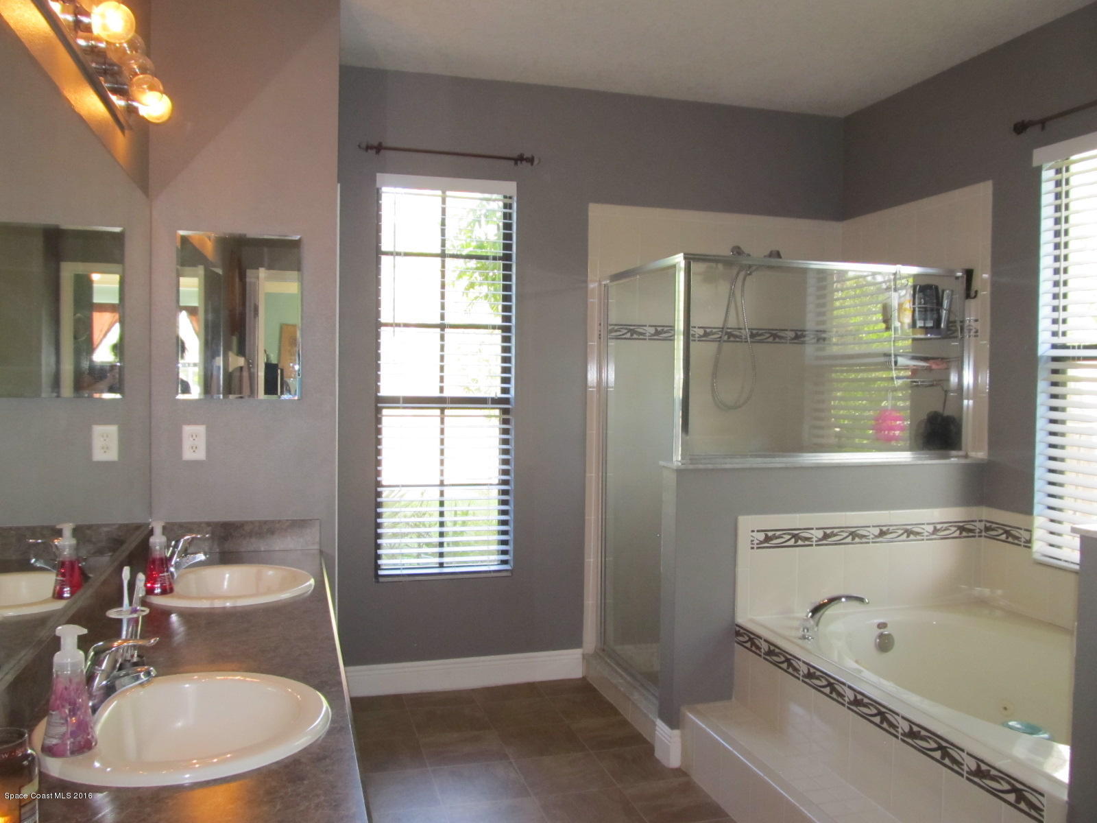 1140 Sexton Road Southwest Palm Bay, FL 32908 - Photo 11 of 20 a bathroom with a tub sink and mirror