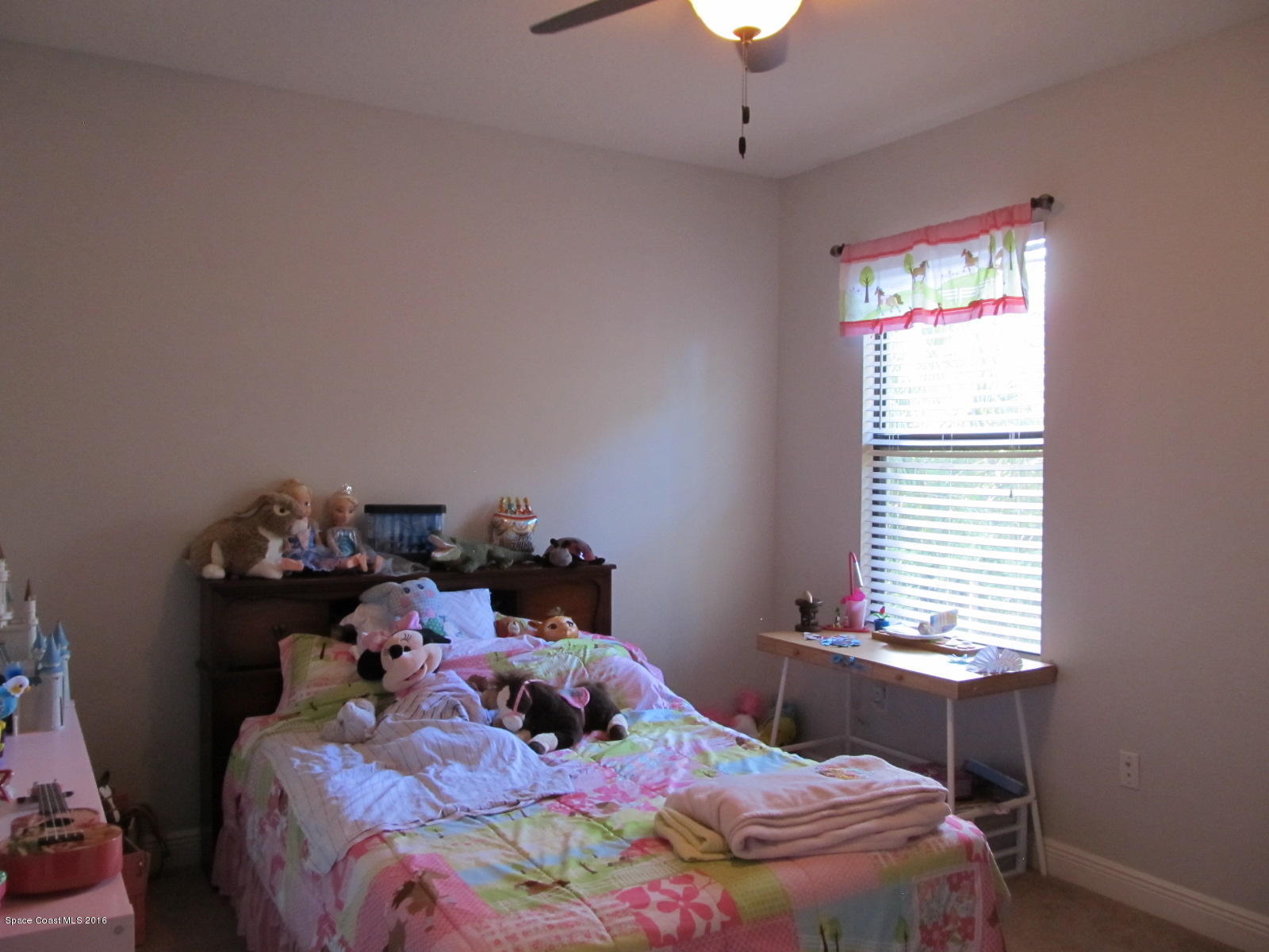 1140 Sexton Road Southwest Palm Bay, FL 32908 - Photo 12 of 20 a bedroom with a bed and a window