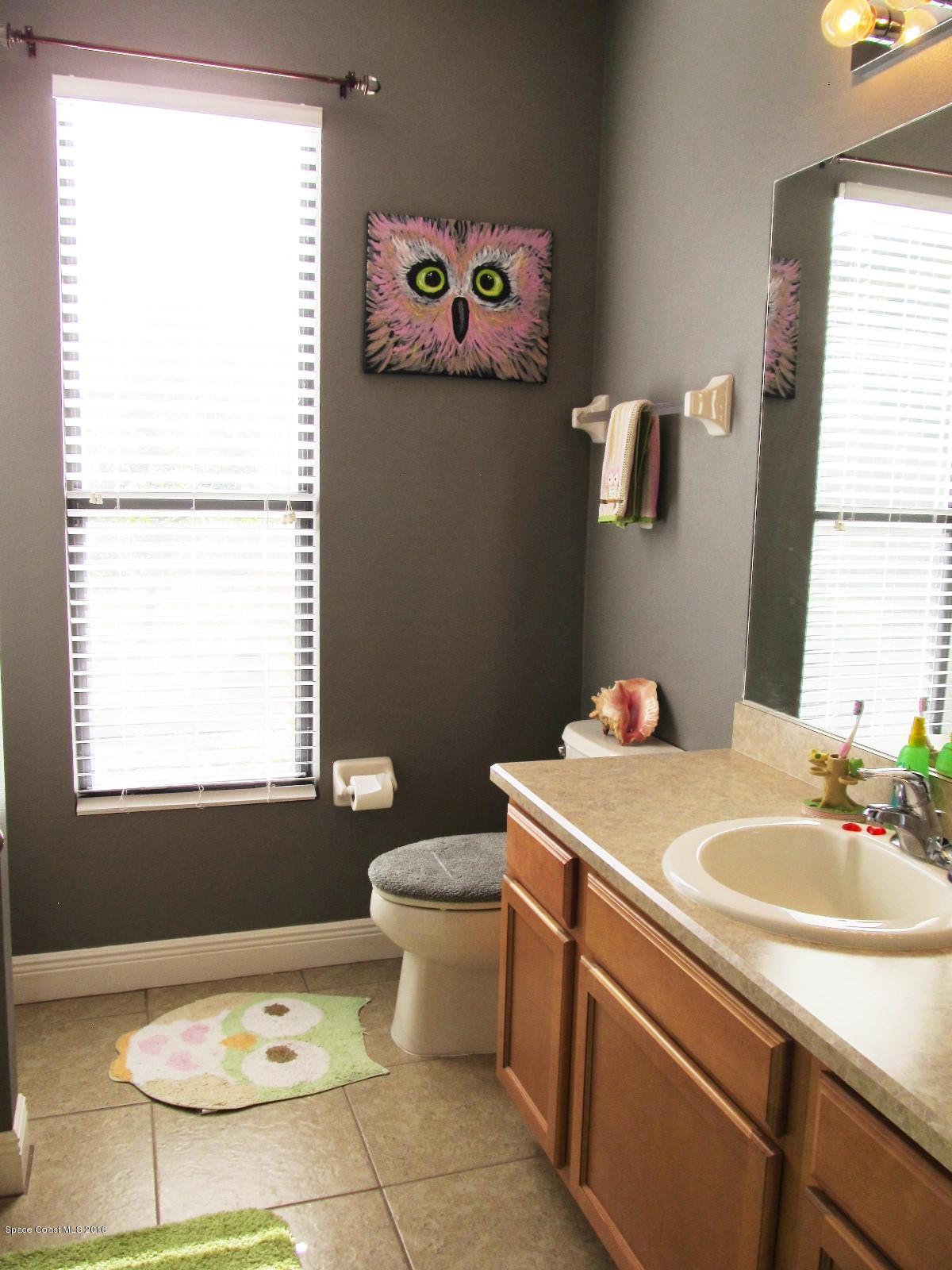 1140 Sexton Road Southwest Palm Bay, FL 32908 - Photo 13 of 20 a bathroom with a sink toilet and a window