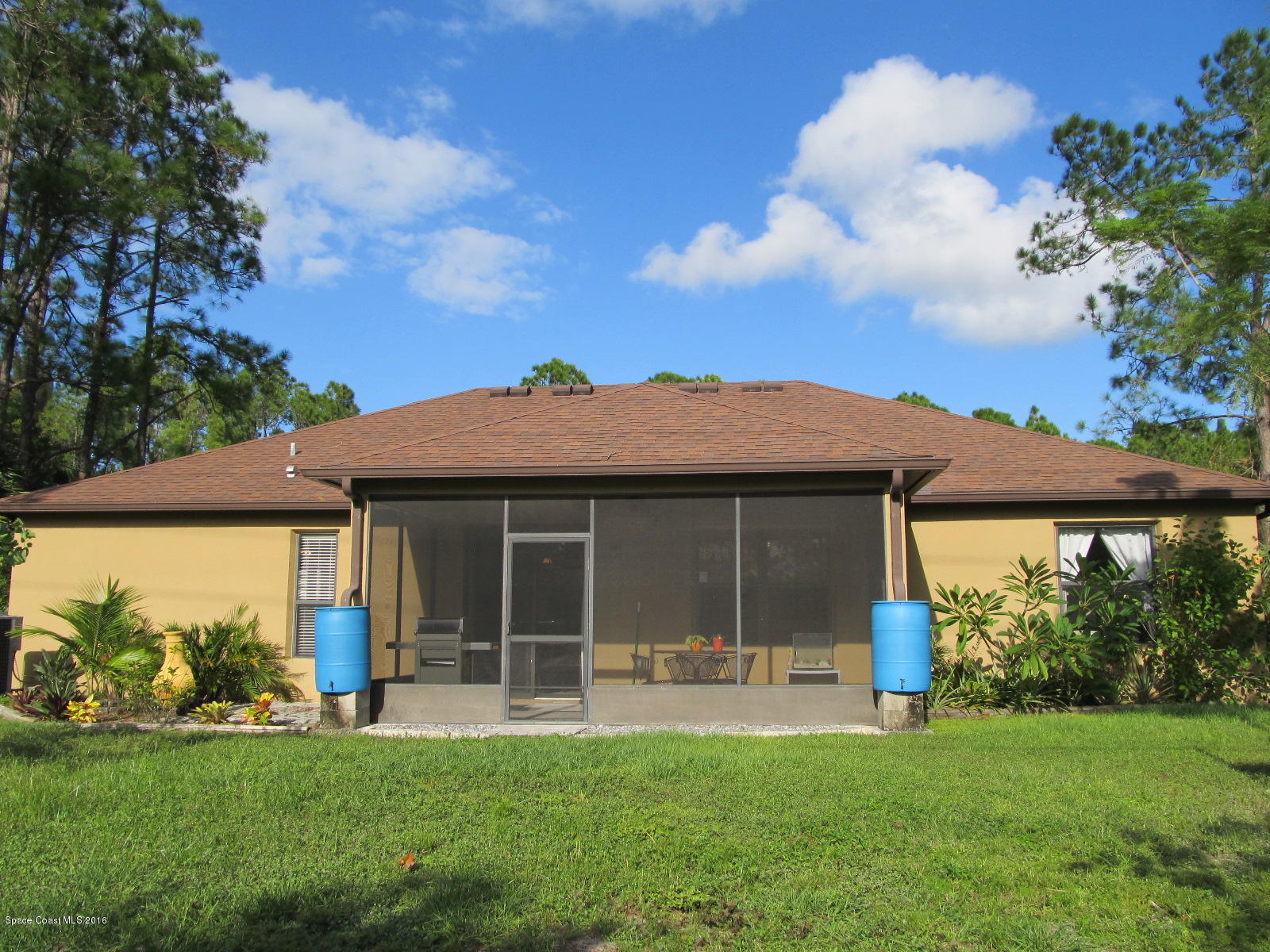 1140 Sexton Road Southwest Palm Bay, FL 32908 - Photo 15 of 20 a view of a house with a yard and a garden