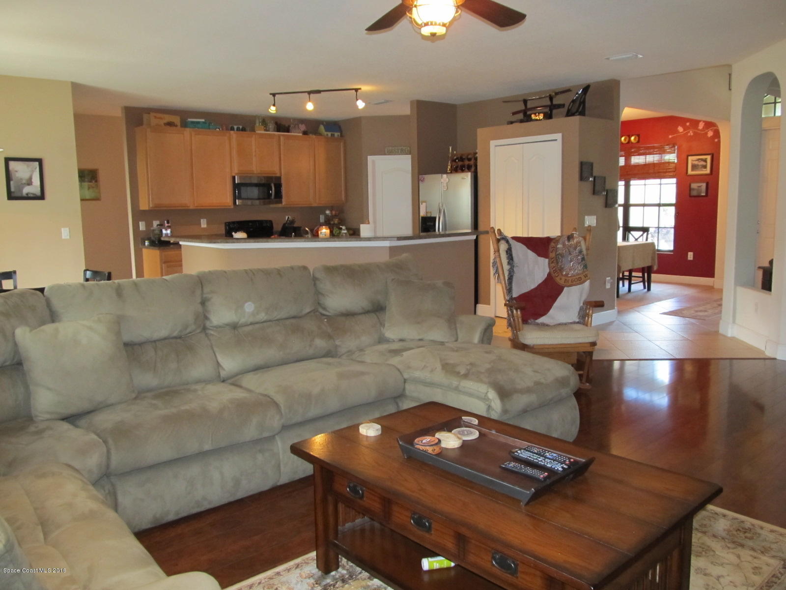 1140 Sexton Road Southwest Palm Bay, FL 32908 - Photo 6 of 20 a living room with furniture and a dining table with wooden floor