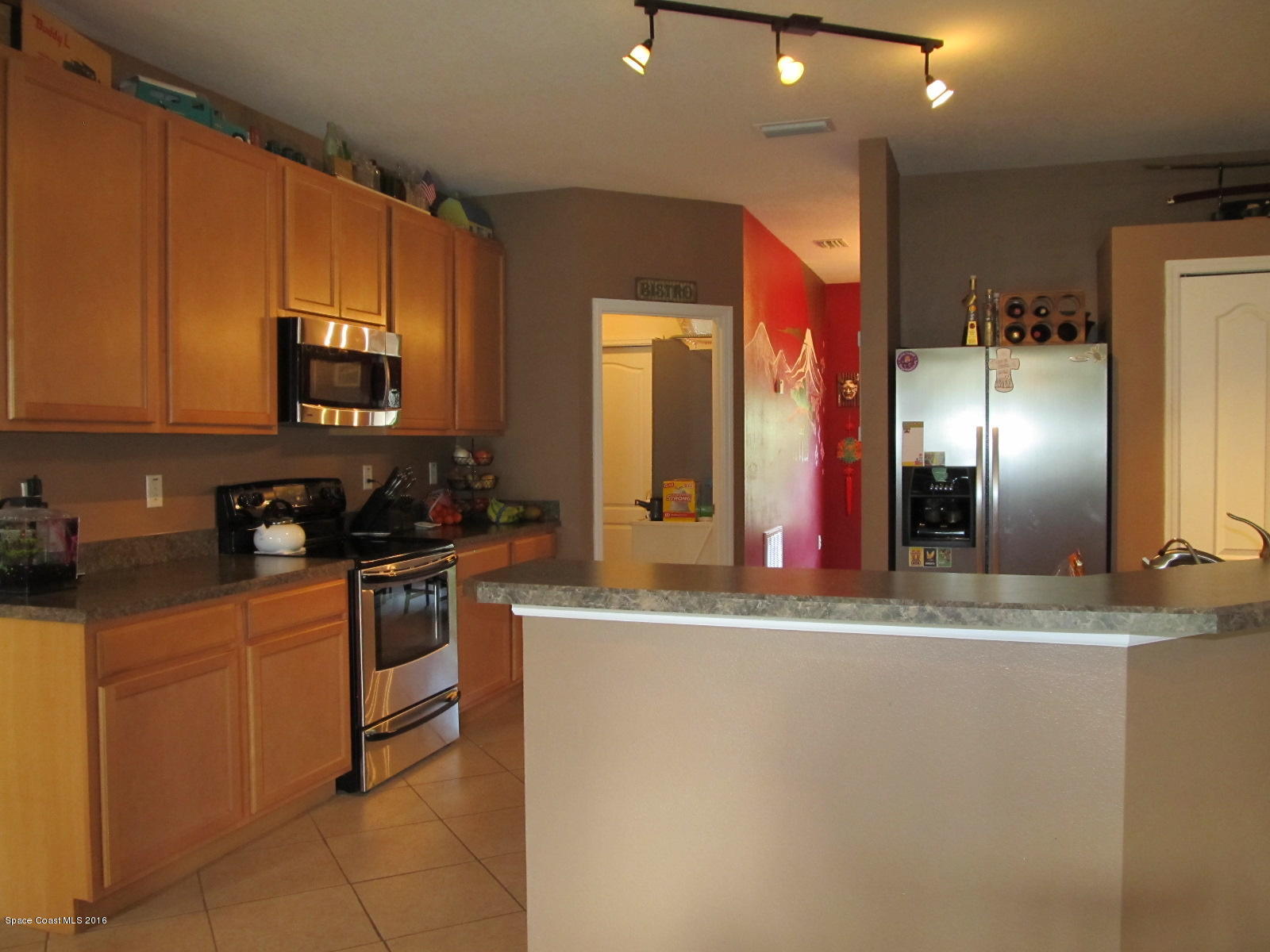 1140 Sexton Road Southwest Palm Bay, FL 32908 - Photo 8 of 20 a kitchen with stainless steel appliances granite countertop a sink and a refrigerator