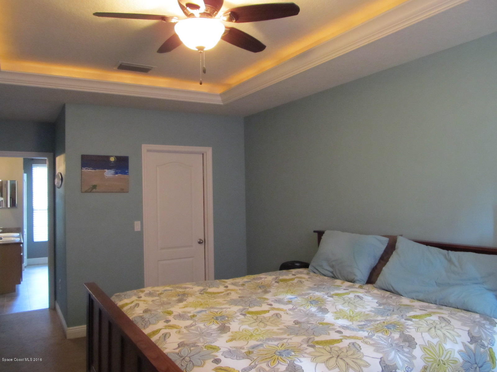 1140 Sexton Road Southwest Palm Bay, FL 32908 - Photo 10 of 20 a bedroom with a bed and a chandelier