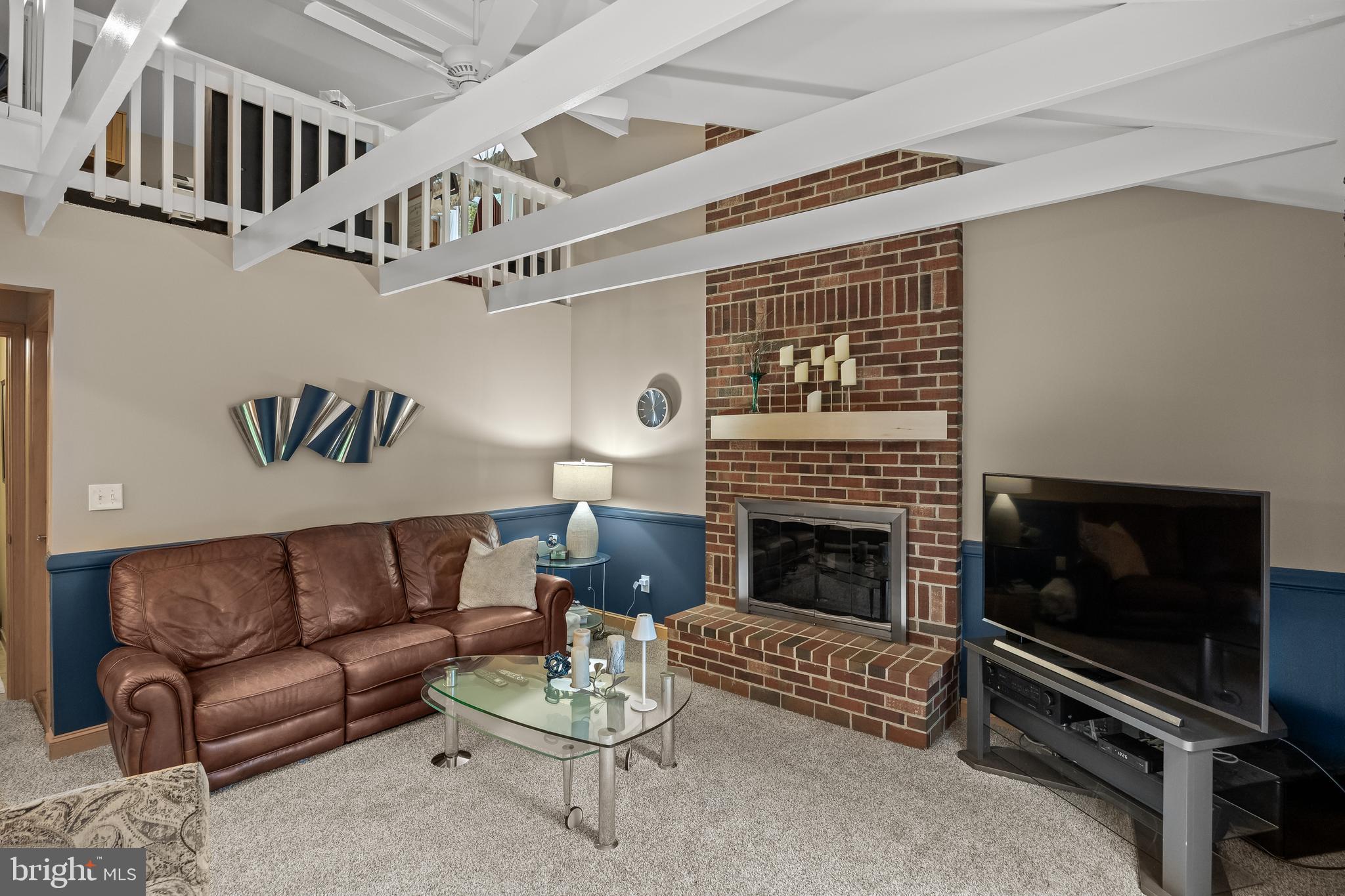209 Tinder Marlton, NJ 08053 - Photo 17 of 47 a living room with furniture a flat screen tv and a fireplace