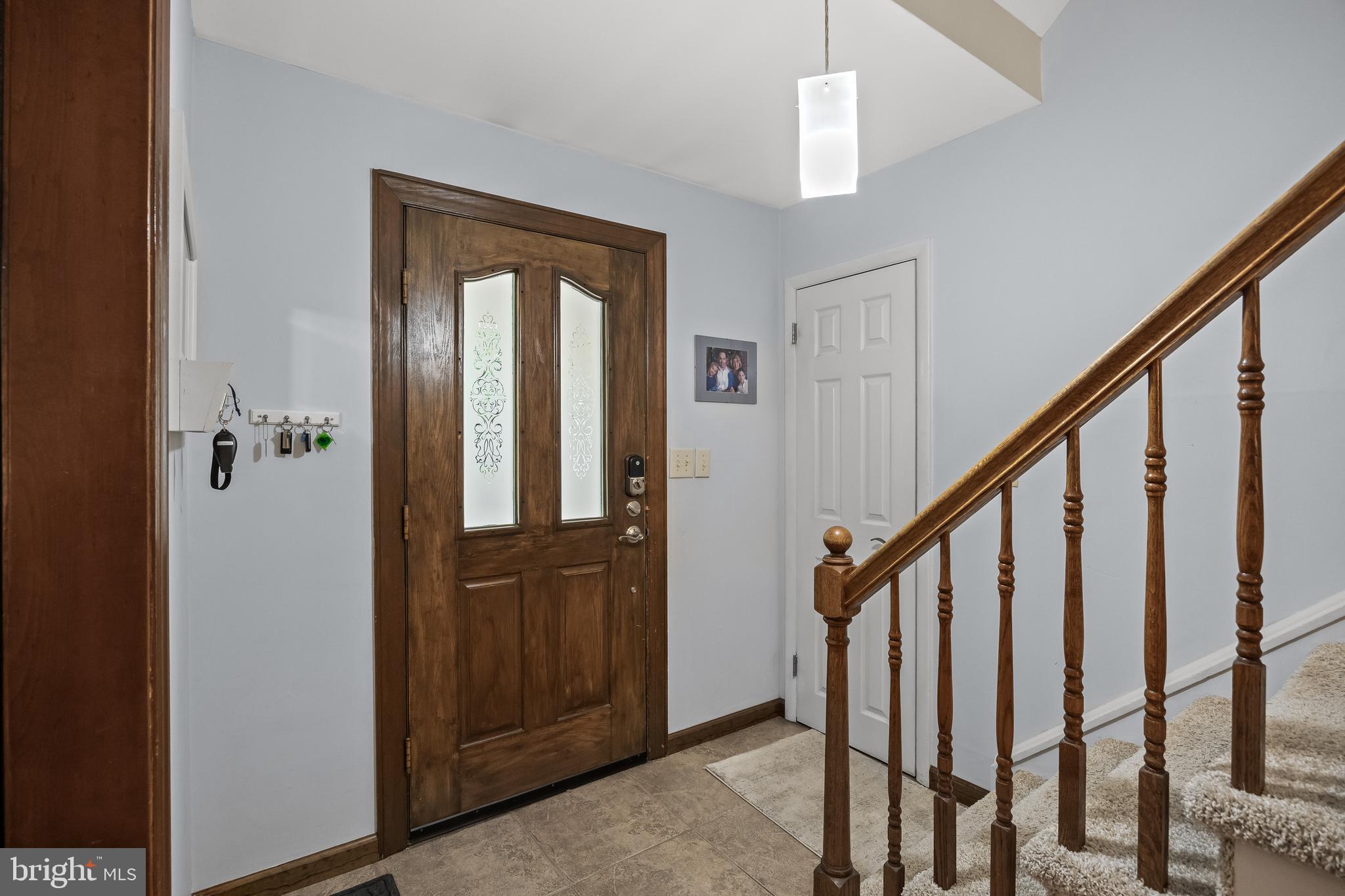 209 Tinder Marlton, NJ 08053 - Photo 4 of 47 a view of a hallway with wooden floor and staircase