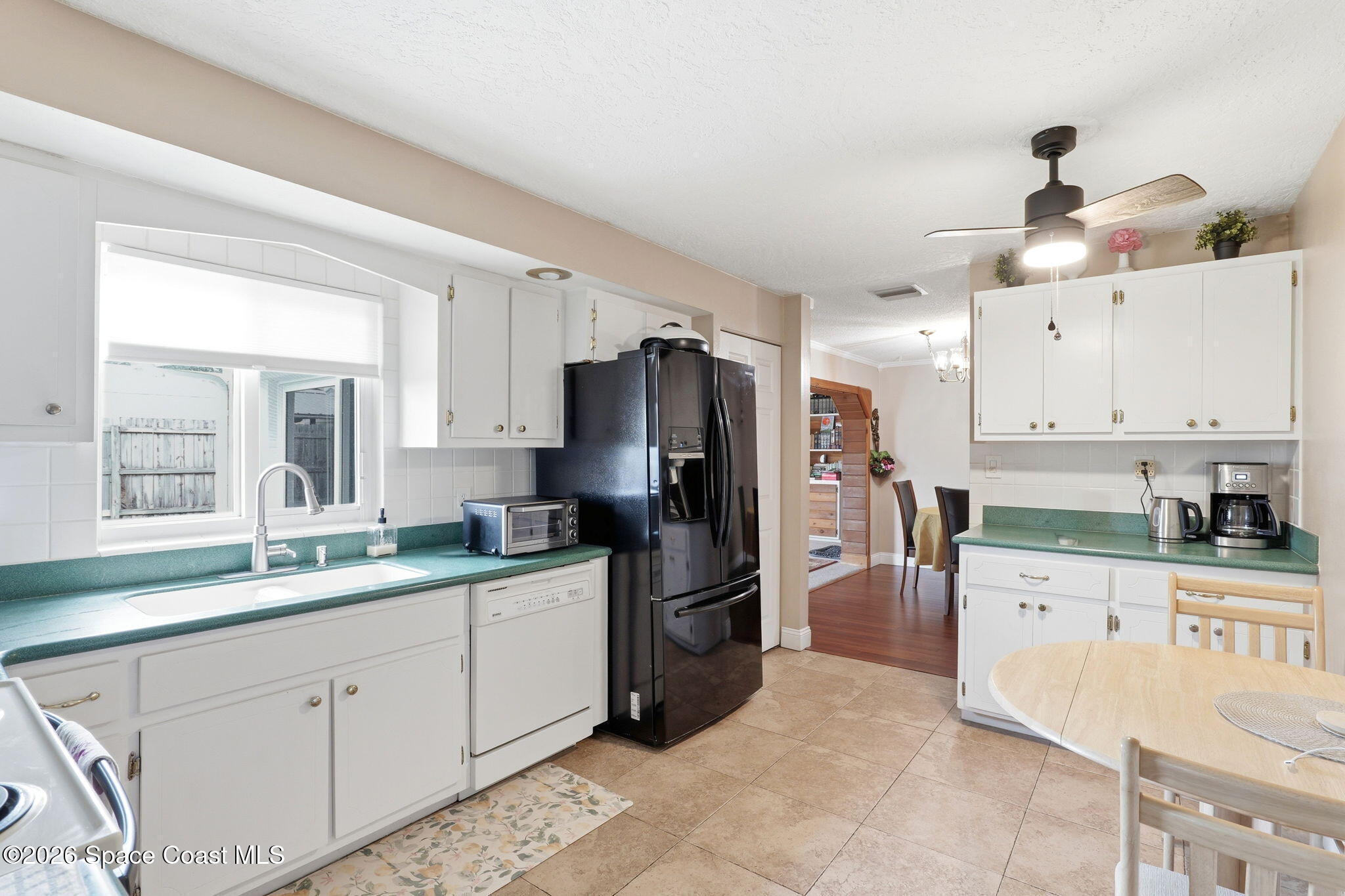 908 Jefferson Road Rockledge, FL 32955 - Photo 15 of 37 a kitchen with stainless steel appliances a refrigerator sink and cabinets