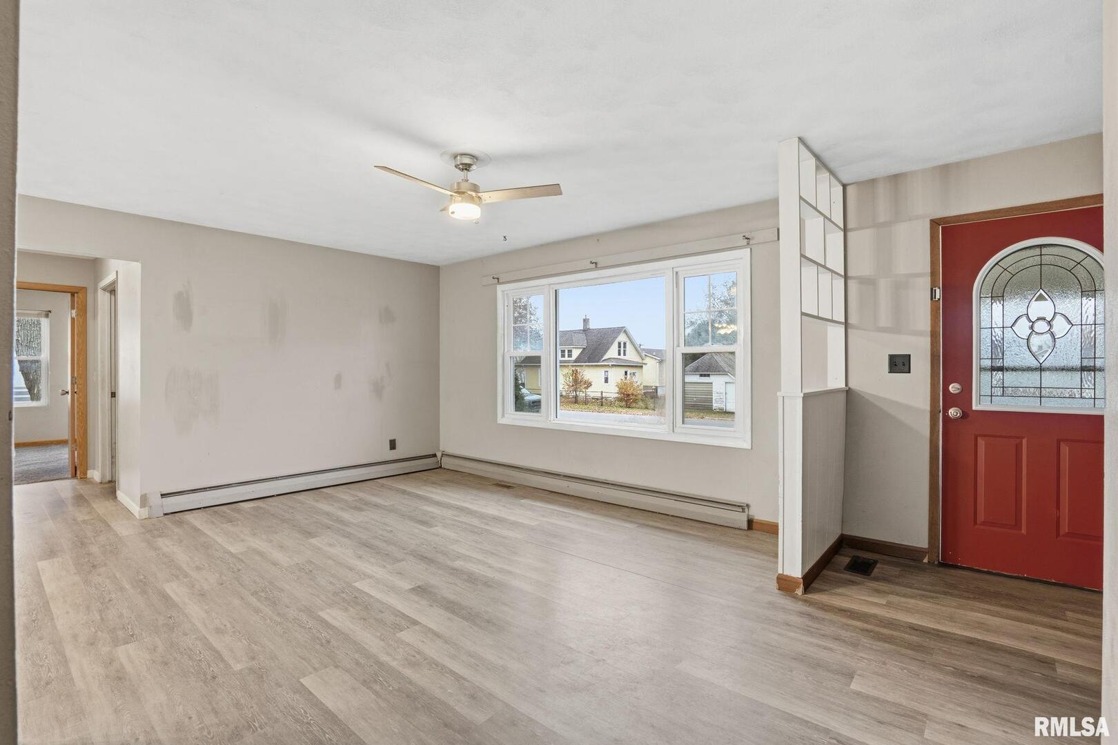 516 4th Street Buffalo, IA 52728 - Photo 3 of 26 an empty room with windows and cabinet