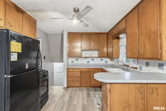 a kitchen with a sink appliances and cabinets