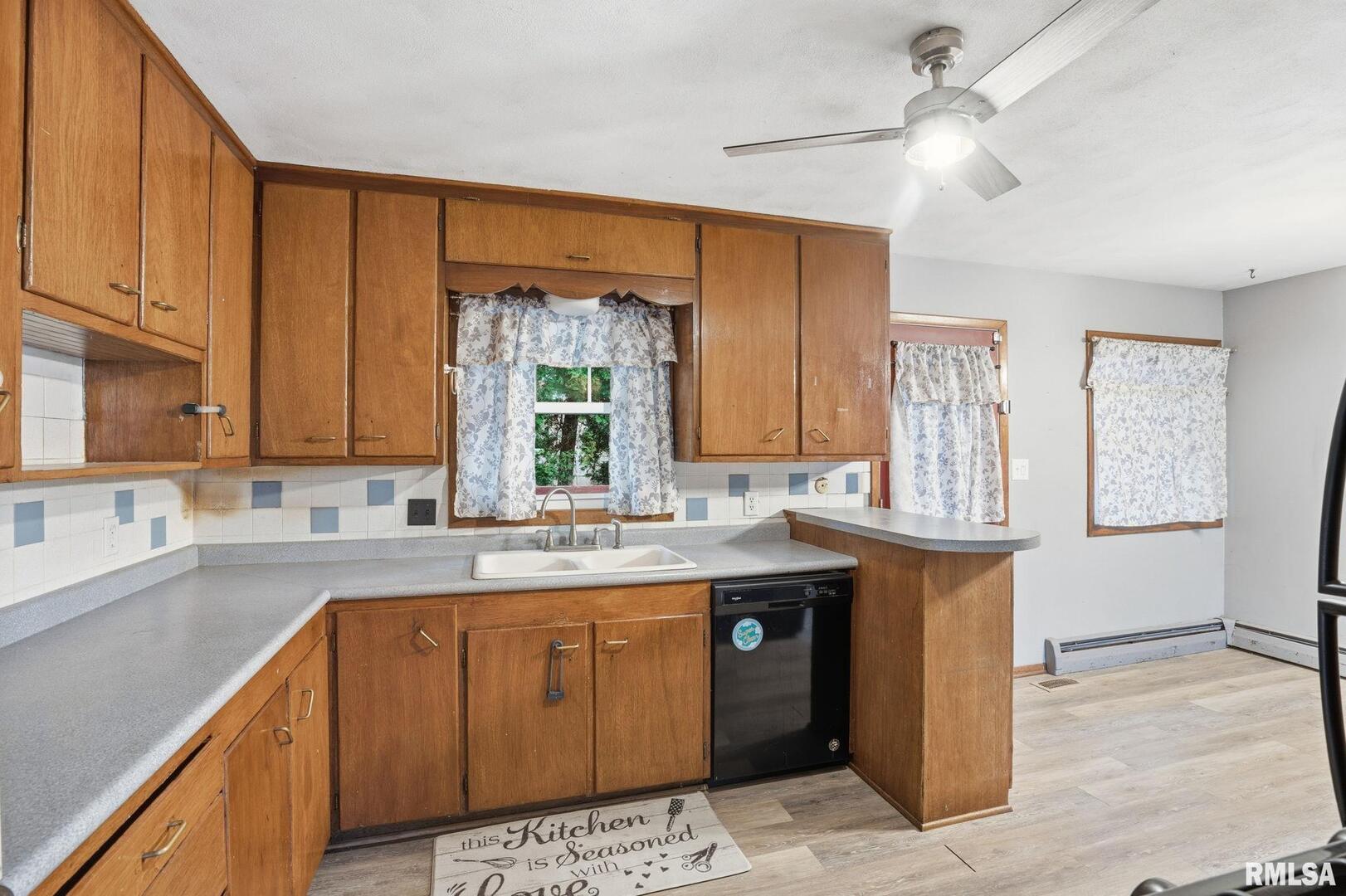 516 4th Street Buffalo, IA 52728 - Photo 7 of 26 a kitchen with a sink and a window