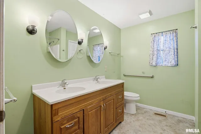 a bathroom with a toilet sink and mirror