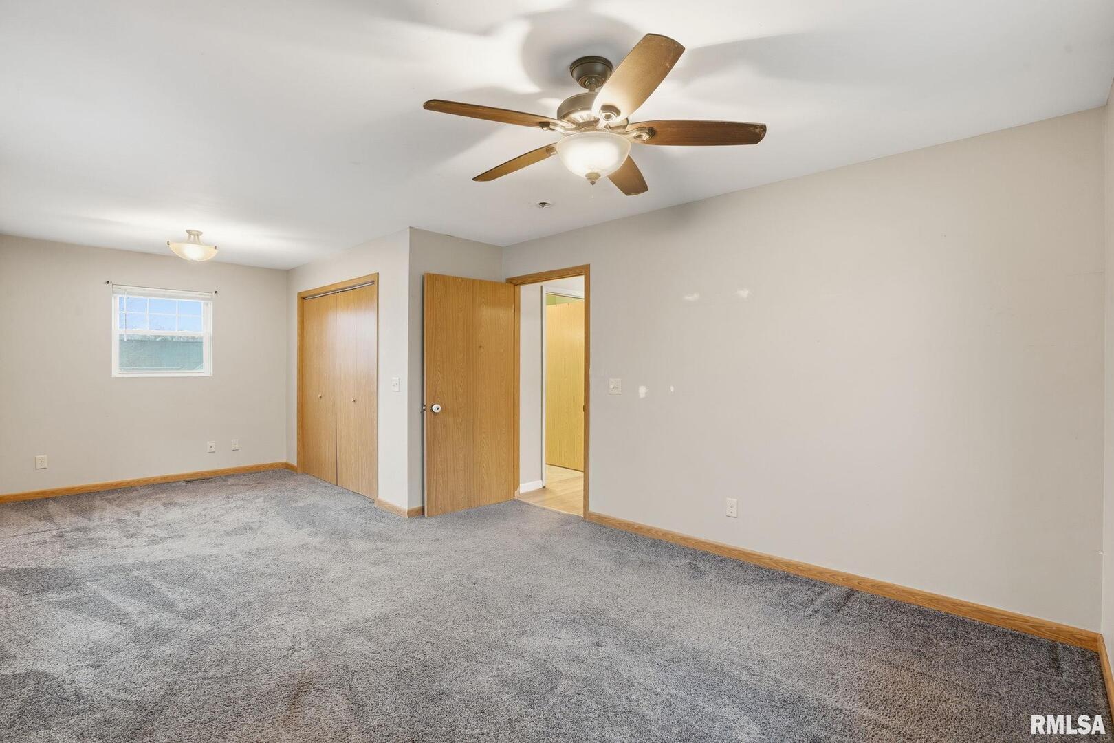 516 4th Street Buffalo, IA 52728 - Photo 10 of 26 an empty room with fan and windows