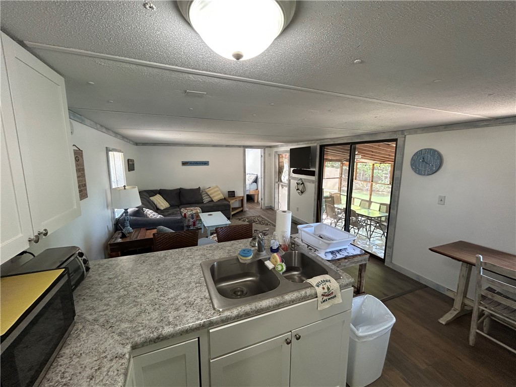 43 Sunset Cove Road Abbeville, SC 29620 - Photo 6 of 41 This inviting space combines a functional kitchen with a comfortable living area, ideal for relaxed gatherings.