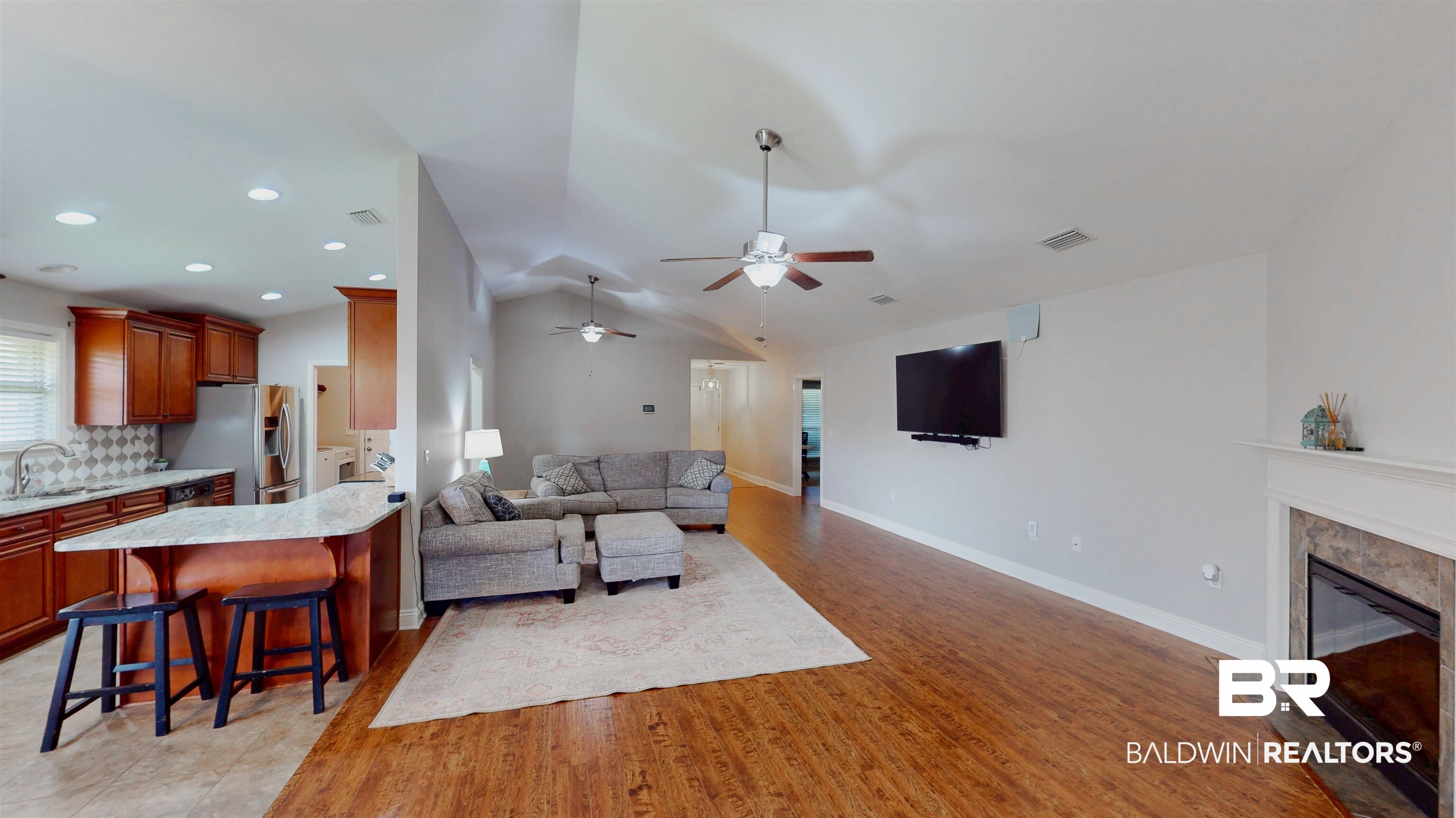 1704 Arcadia Drive Foley, AL 36535 - Photo 20 of 52 Living room with ceiling fan, a high end fireplace, light wood-style flooring, vaulted ceiling, and recessed lighting