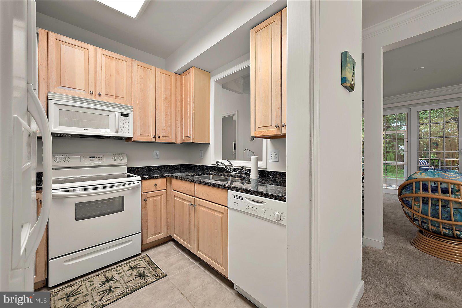 30611 Cedar Neck Road, Unit 2107 Ocean View, DE 19970 - Photo 12 of 44 a kitchen with stainless steel appliances granite countertop a stove a sink and a refrigerator