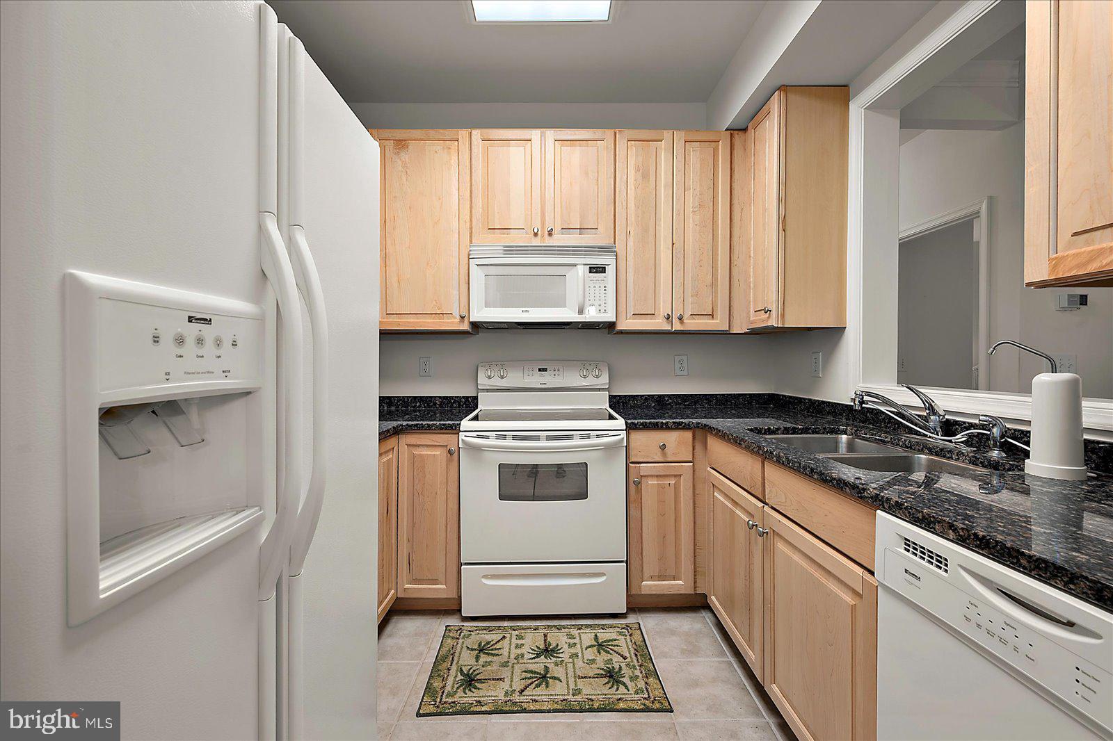30611 Cedar Neck Road, Unit 2107 Ocean View, DE 19970 - Photo 13 of 44 a kitchen with stainless steel appliances granite countertop a stove a sink and a refrigerator