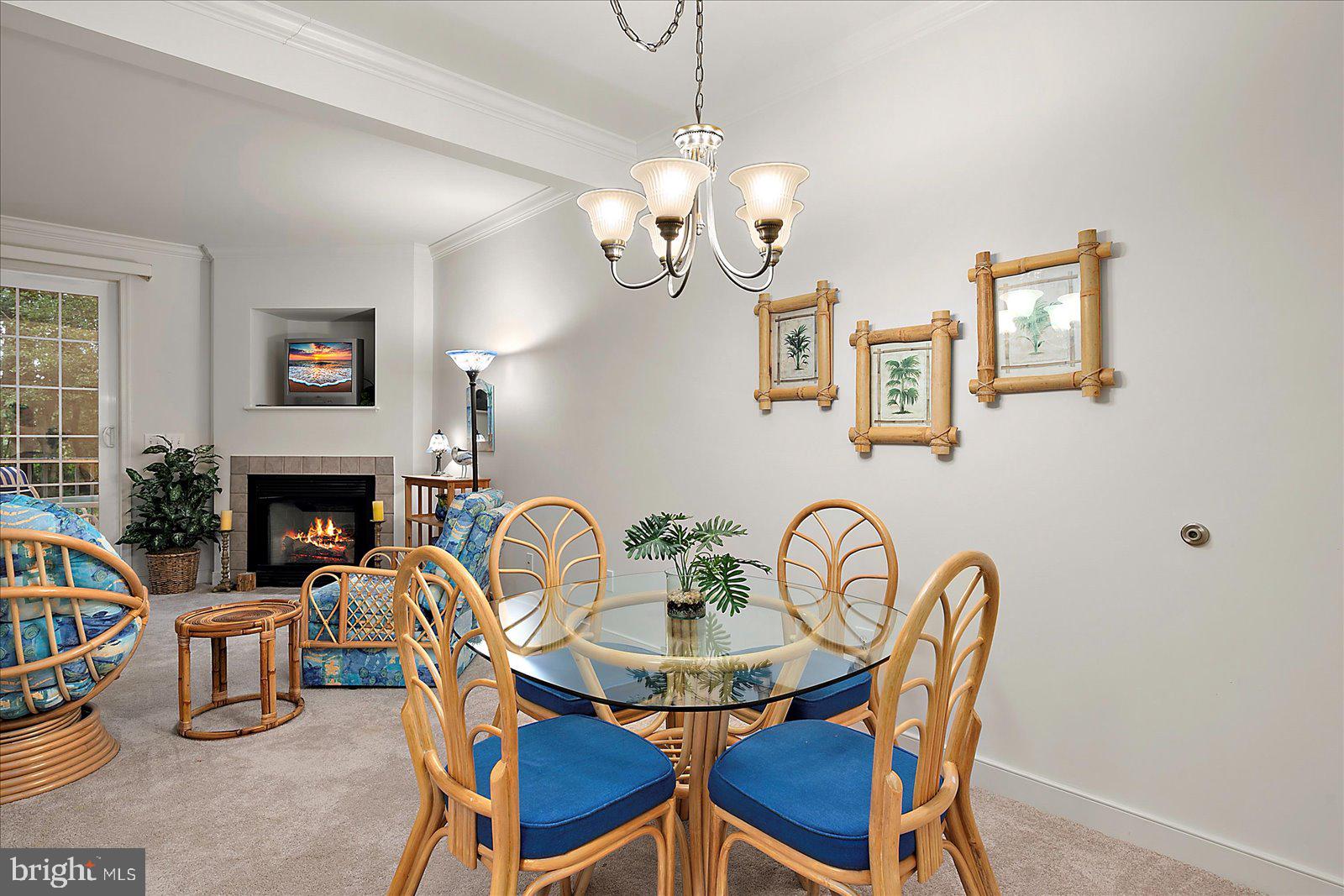 30611 Cedar Neck Road, Unit 2107 Ocean View, DE 19970 - Photo 15 of 44 a view of a dining room with furniture and a chandelier