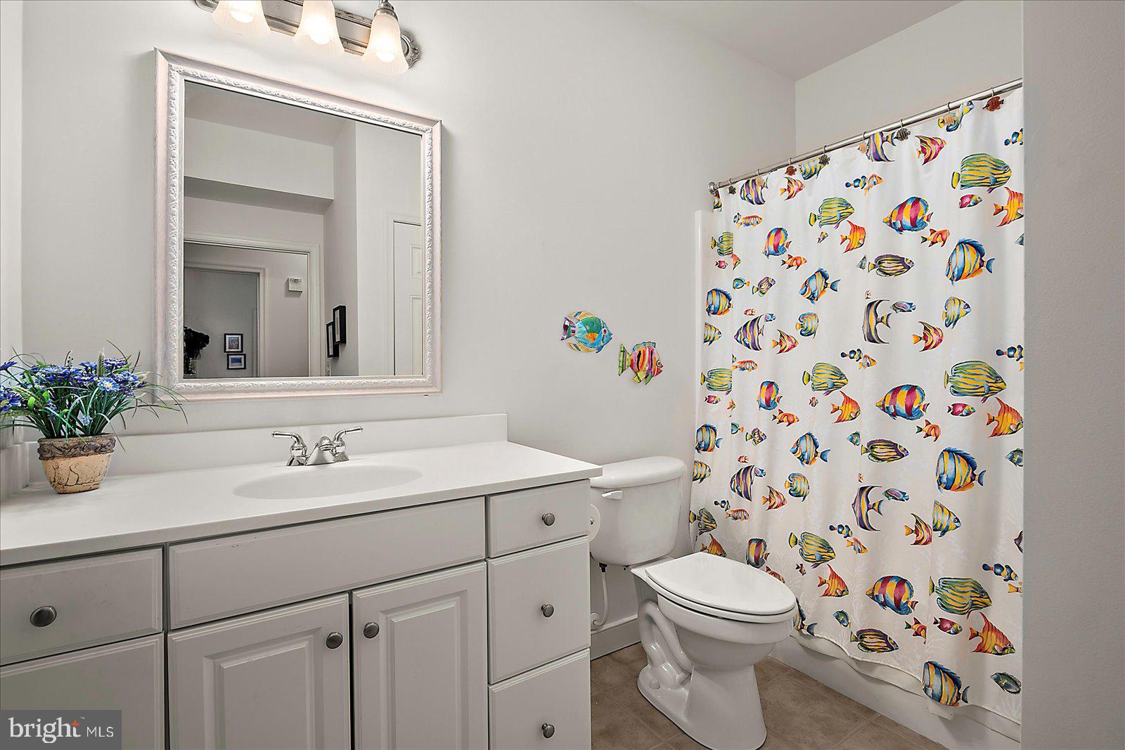 30611 Cedar Neck Road, Unit 2107 Ocean View, DE 19970 - Photo 17 of 44 a bathroom with a sink a toilet and a mirror