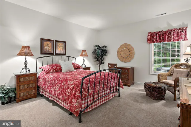 a bed room with a bed mirror and a window