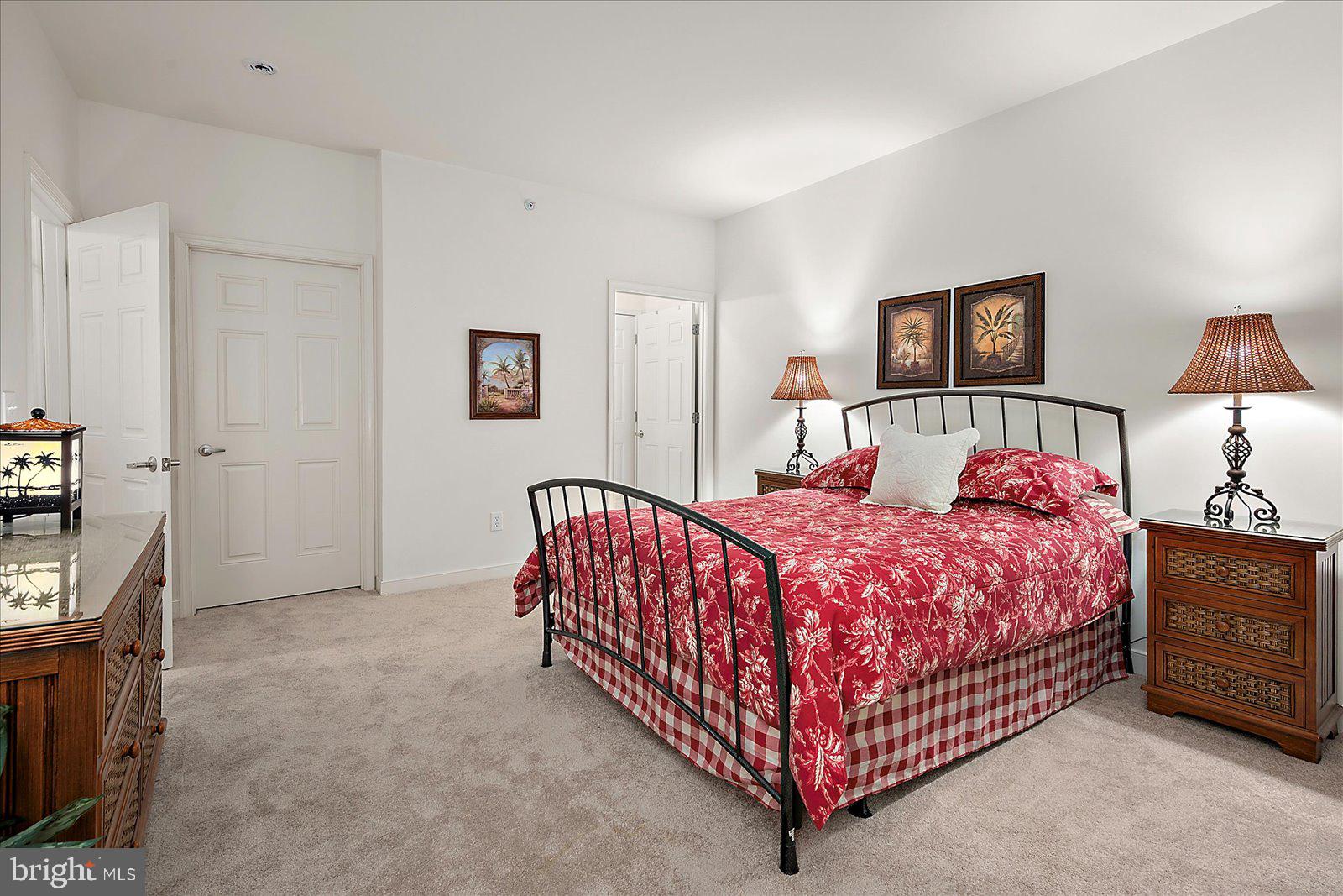 30611 Cedar Neck Road, Unit 2107 Ocean View, DE 19970 - Photo 20 of 44 a bed room with a bed and a lamp