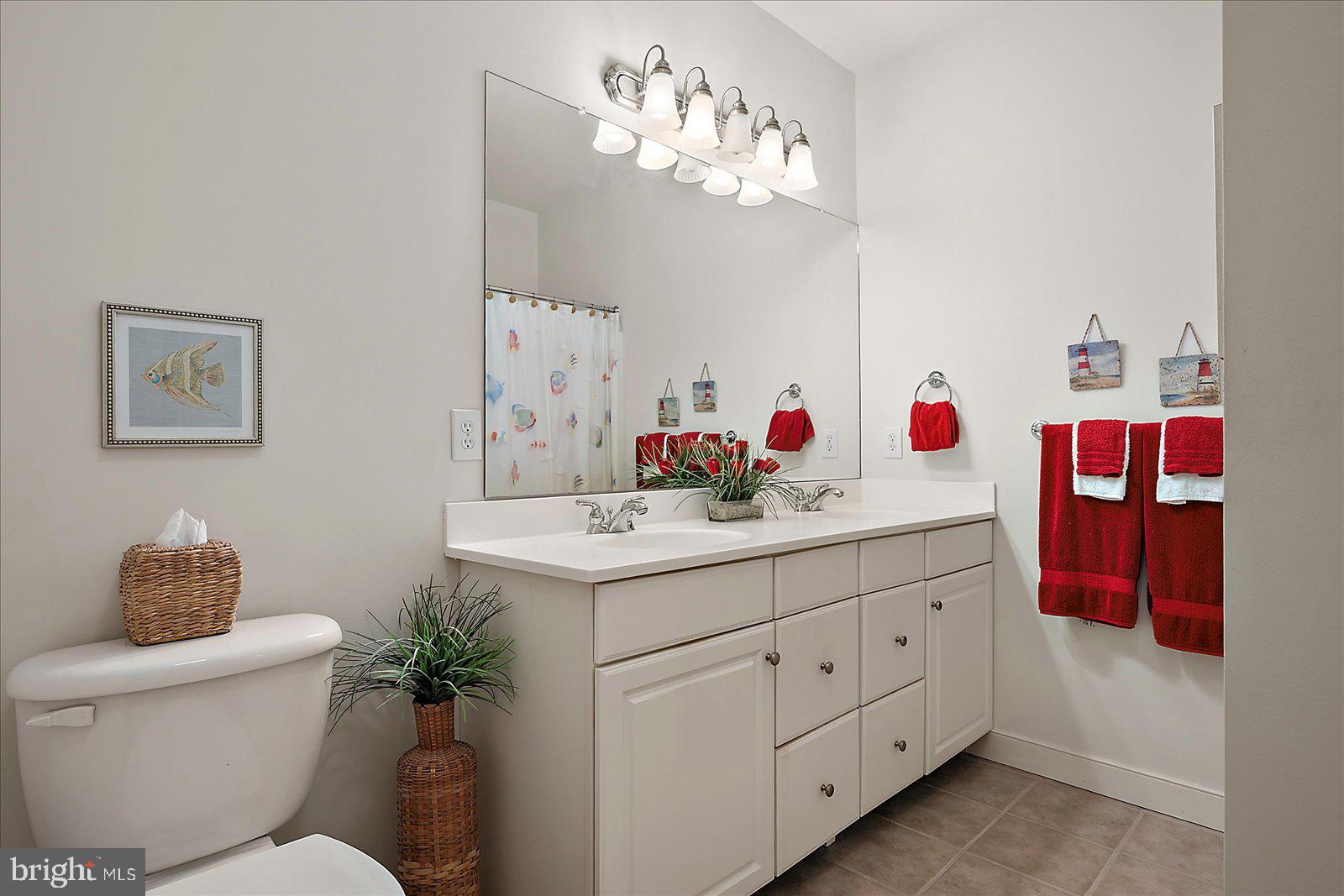 30611 Cedar Neck Road, Unit 2107 Ocean View, DE 19970 - Photo 22 of 44 a bathroom with a sink double vanity and a toilet