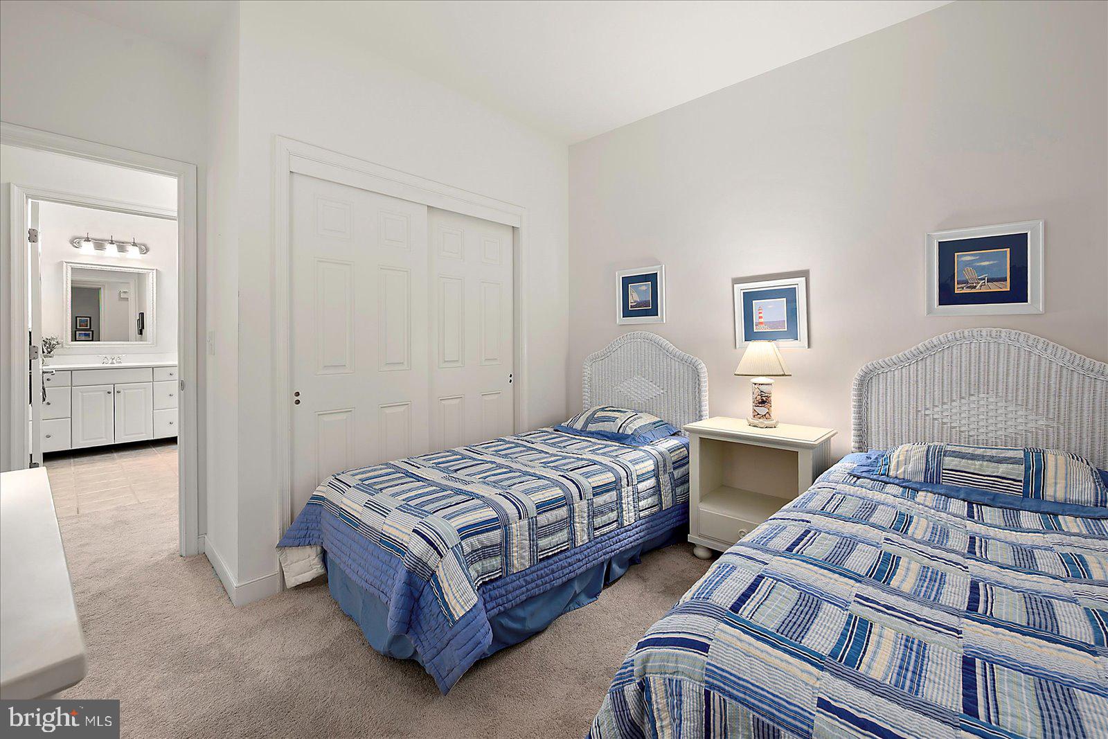 30611 Cedar Neck Road, Unit 2107 Ocean View, DE 19970 - Photo 26 of 44 a bedroom with two beds and painting on the wall