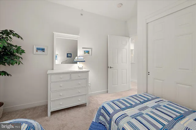 a bedroom with a bed and a dresser in it