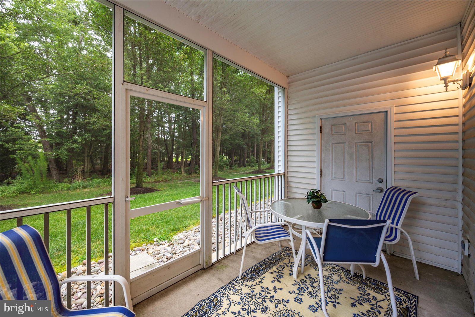 30611 Cedar Neck Road, Unit 2107 Ocean View, DE 19970 - Photo 30 of 44 a view of a chair and table in the balcony