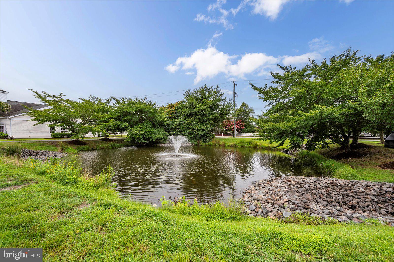 30611 Cedar Neck Road, Unit 2107 Ocean View, DE 19970 - Photo 35 of 44 a view of a lake with a yard and large trees
