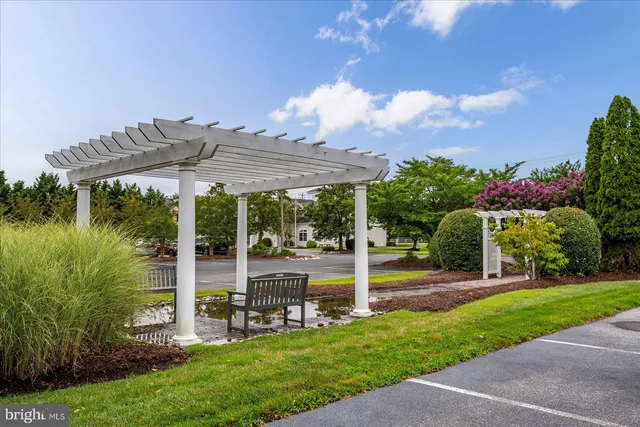 a front view of a house with swimming pool having outdoor seating