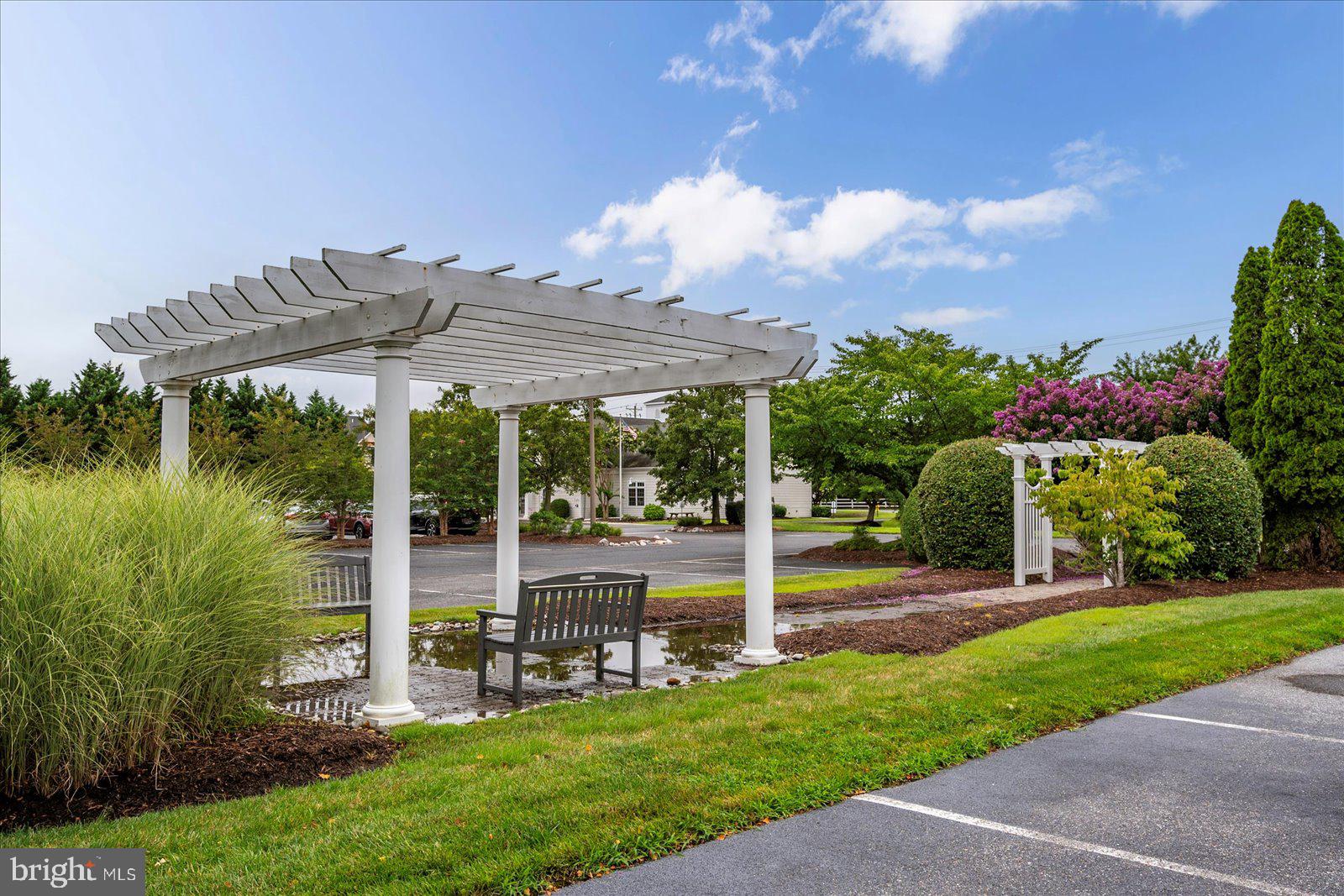 30611 Cedar Neck Road, Unit 2107 Ocean View, DE 19970 - Photo 38 of 44 a view of a house with backyard and a fountain