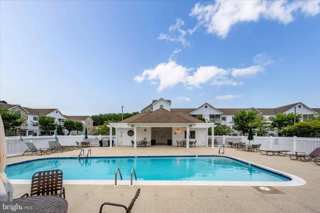 a view of a house with a swimming pool and a chairs