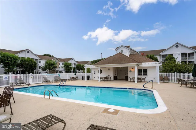 a view of a house with swimming pool and sitting area