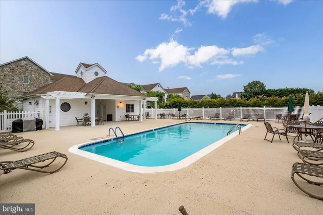 a view of a swimming pool with lounge chair