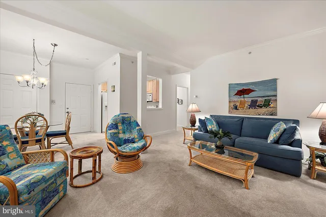 a living room with furniture a chandelier and a mirror