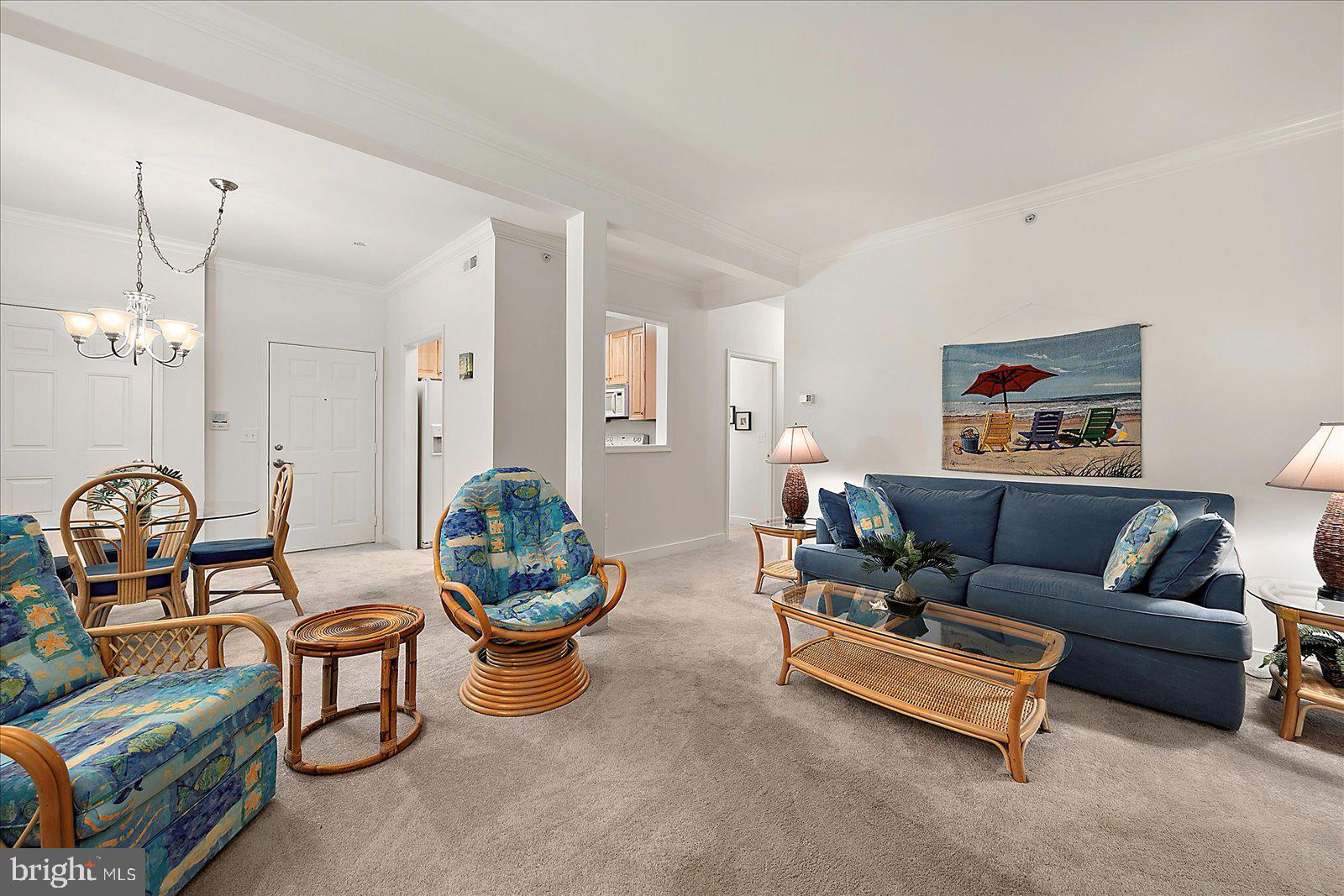 30611 Cedar Neck Road, Unit 2107 Ocean View, DE 19970 - Photo 9 of 44 a living room with furniture a chandelier and a mirror